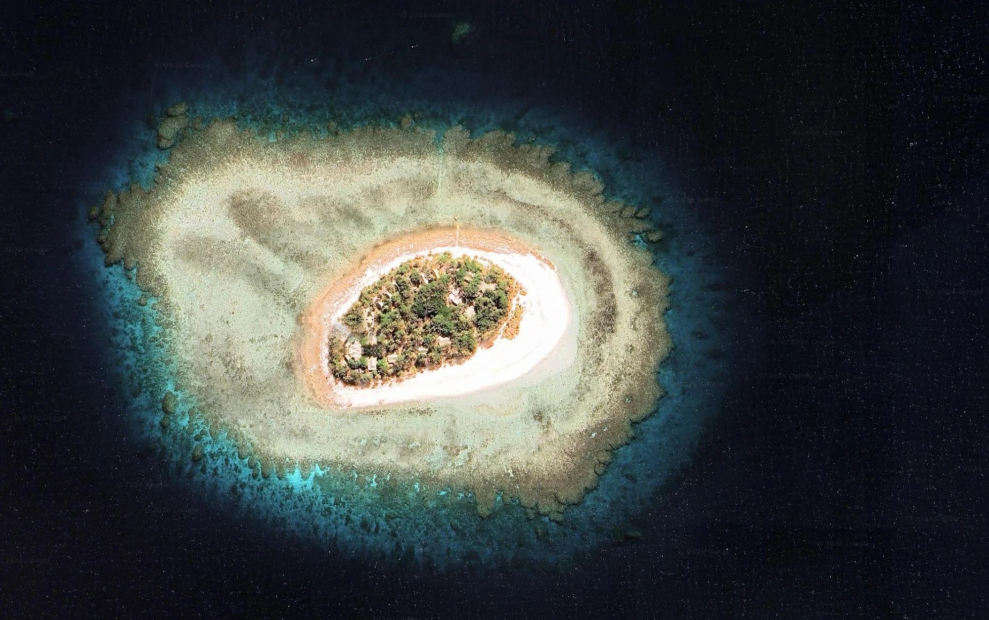 Navini Island from above, inside its ring of coral reef